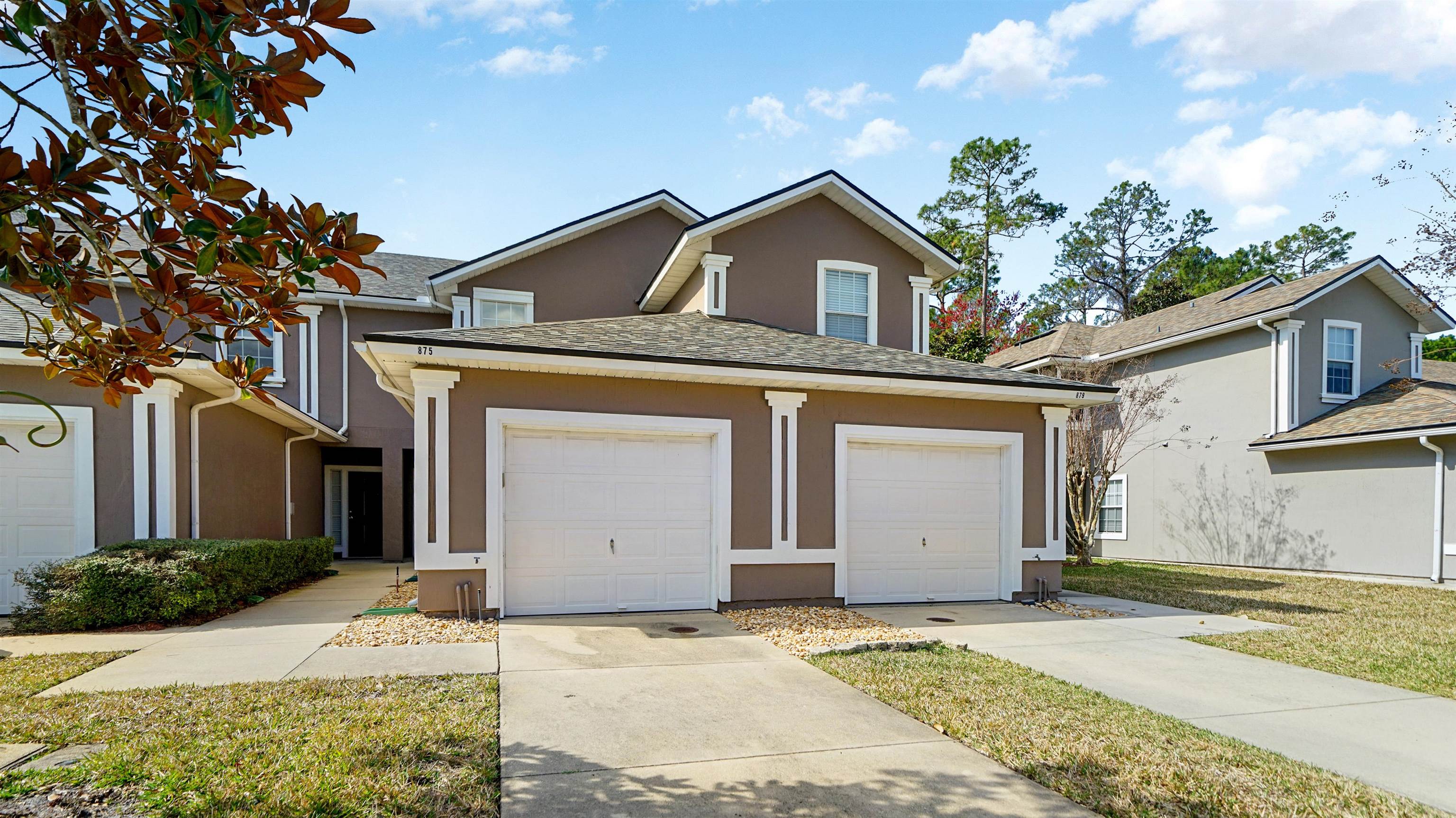 875 Scrub Jay Drive St. Augustine, FL 32092 - Photo 24 of 28 a front view of a house with a yard and garage