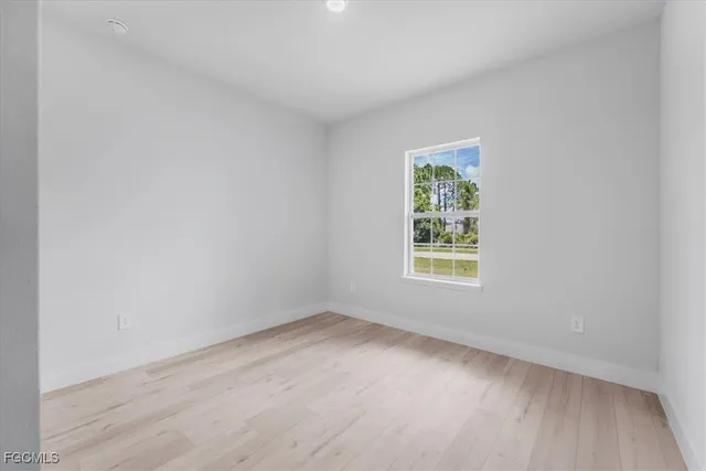 a view of room with window and hardwood floor