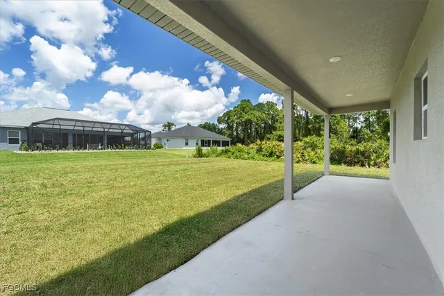 an aerial view of a house with a garden and lake view