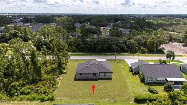 a backyard of a house with table and chairs