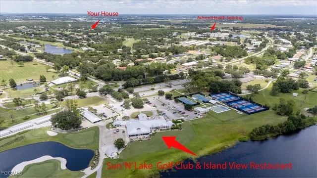 an aerial view of a house with garden space and lake view