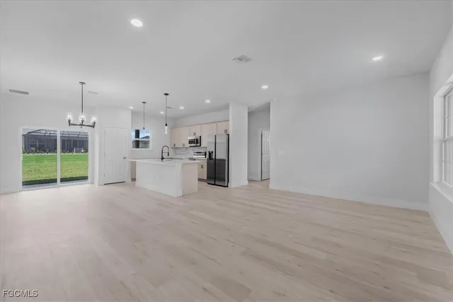 a view of a kitchen with a sink and a window