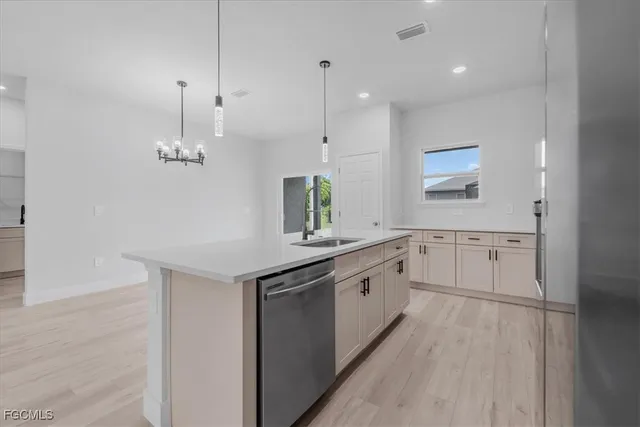 a large kitchen with granite countertop a stove and a sink