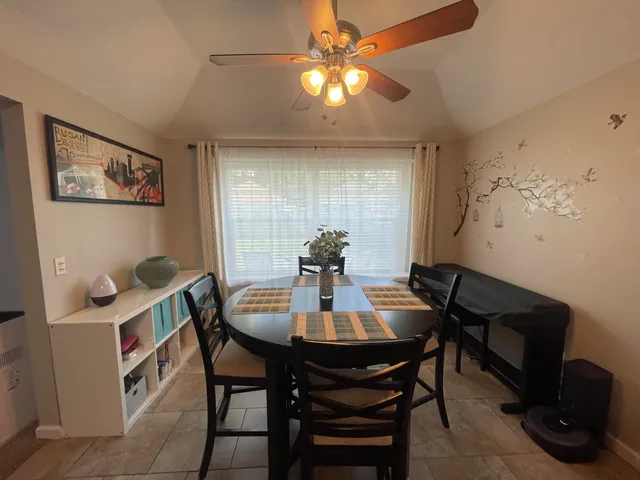 a view of a dining room with furniture and chandelier