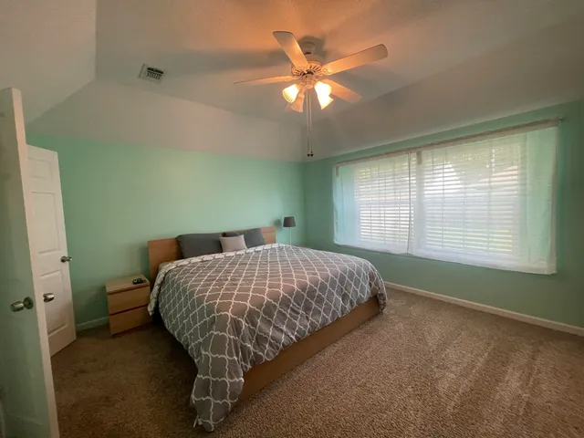 a bed sitting in a room next to a window