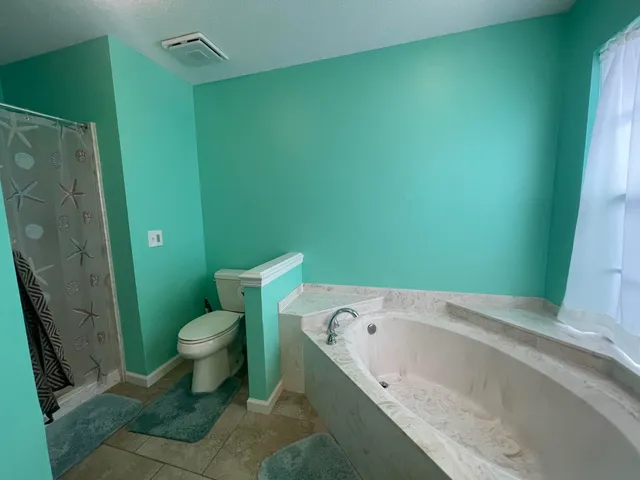 a bathroom with a bathtub and toilet