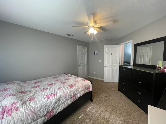 a bedroom with a bed and a chandelier