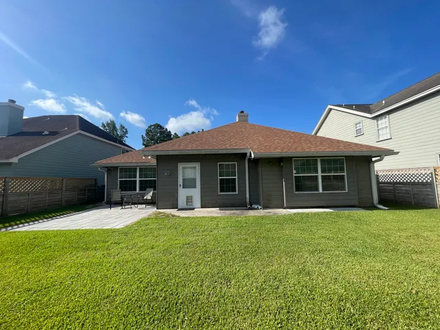 a view of a house with a yard and sitting area