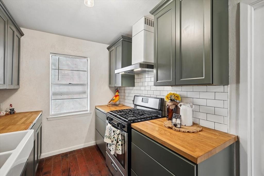 2508 West Rochelle Road Irving, TX 75062 - Photo 6 of 19 a kitchen with stainless steel appliances granite countertop a sink stove and cabinets