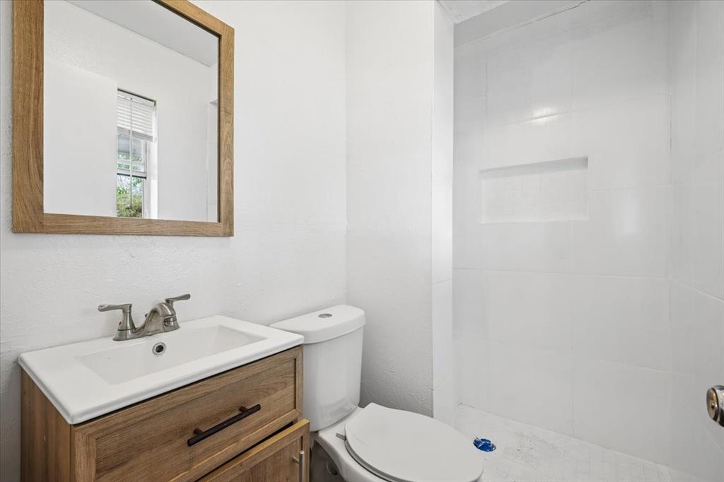 2508 West Rochelle Road Irving, TX 75062 - Photo 9 of 19 a bathroom with a sink a toilet and shower