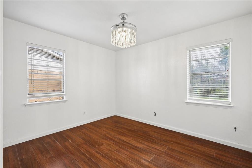 2508 West Rochelle Road Irving, TX 75062 - Photo 10 of 19 a view of an empty room with wooden floor and a window