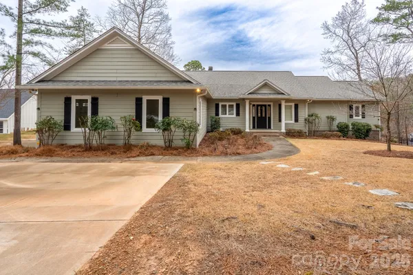 a front view of a house with yard porch and outdoor seating