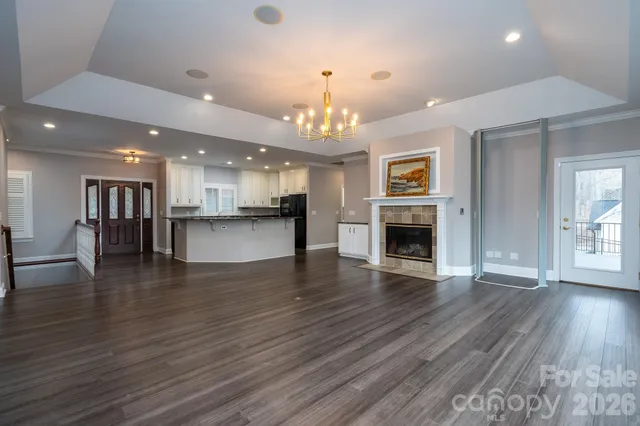 a spacious bedroom with a large bed and a chandelier