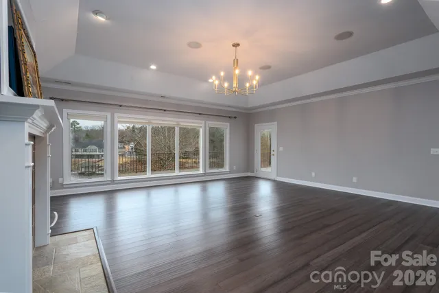 a spacious bedroom with a large bed and wooden floor