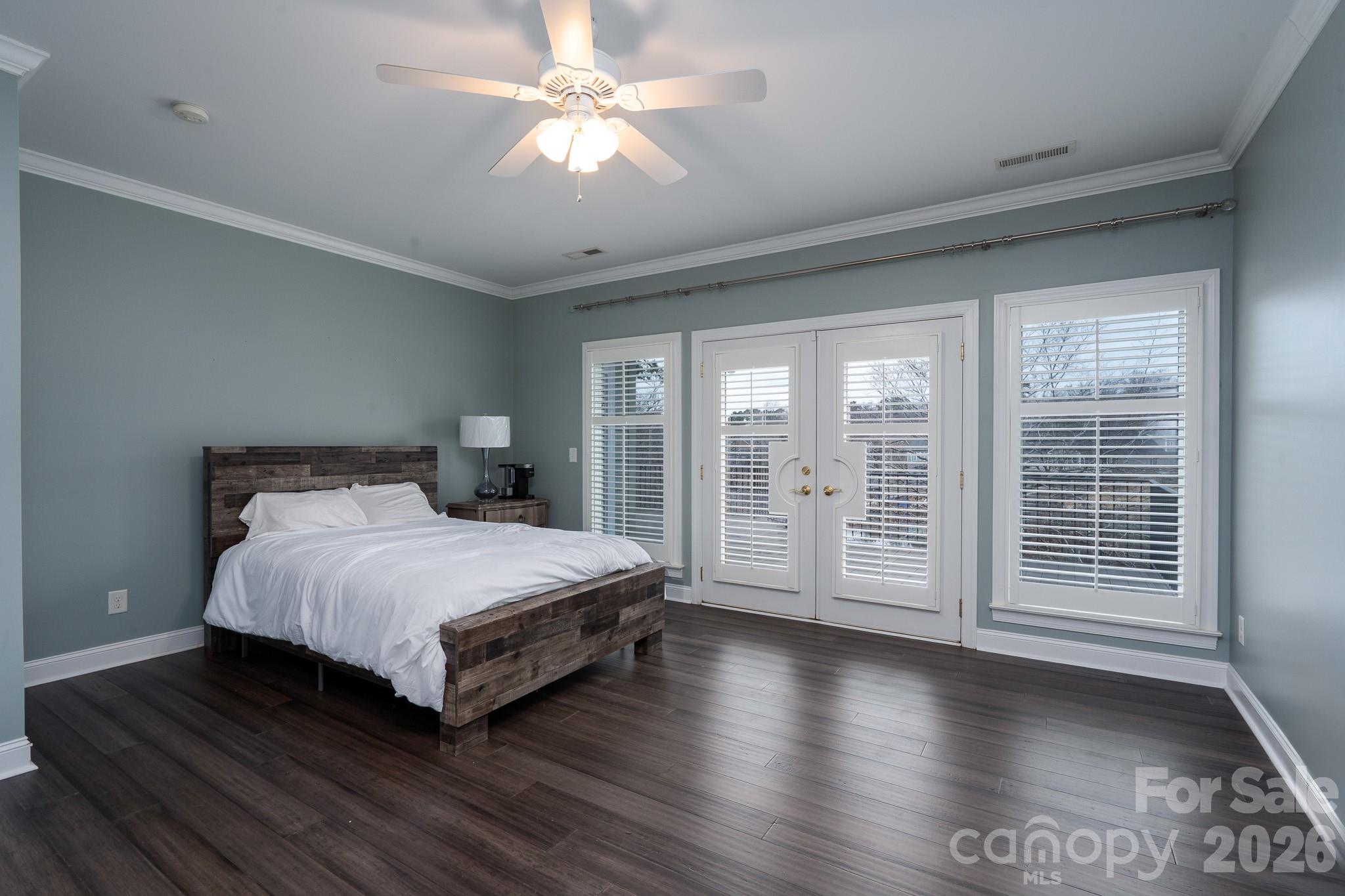 338 PLANTATION Way Mount Gilead, NC 27306 - Photo 22 of 48 a spacious bedroom with a large bed and wooden floor