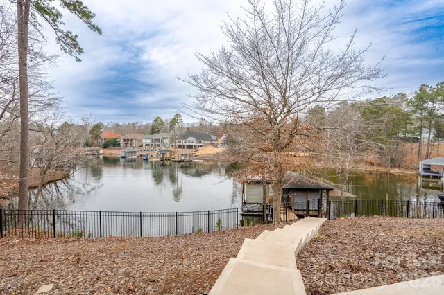 a view of a white house with a large space in front of it