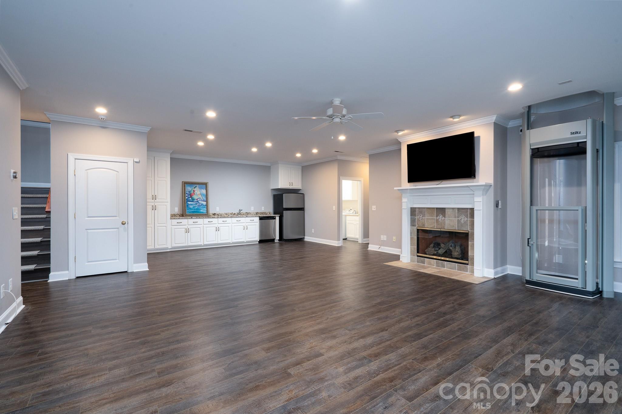 338 PLANTATION Way Mount Gilead, NC 27306 - Photo 33 of 48 a view of empty room with wooden floor and a fireplace