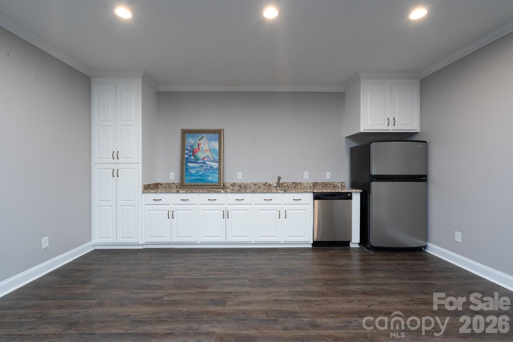 338 PLANTATION Way Mount Gilead, NC 27306 - Photo 35 of 48 a kitchen with a sink cabinets and wooden floor