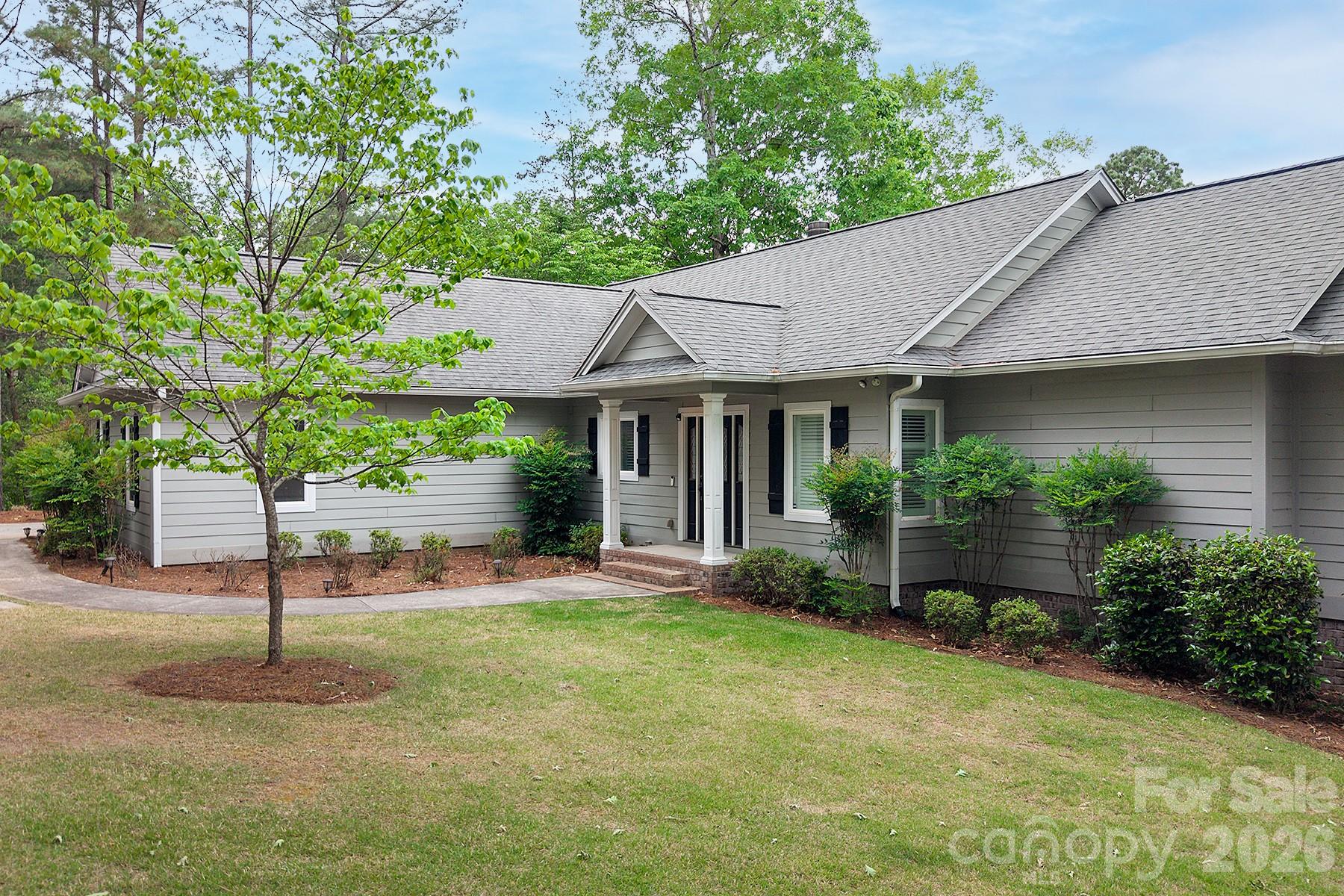 338 PLANTATION Way Mount Gilead, NC 27306 - Photo 5 of 48 a front view of a house with garden