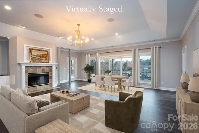 a living room with furniture fireplace and a large window