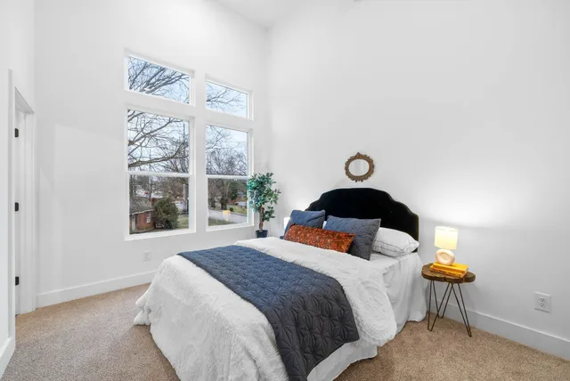a bedroom with a bed and hallway
