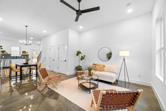 a living room with furniture a rug and a chandelier