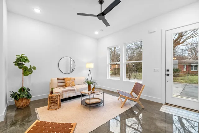 a living room with furniture and next to a window