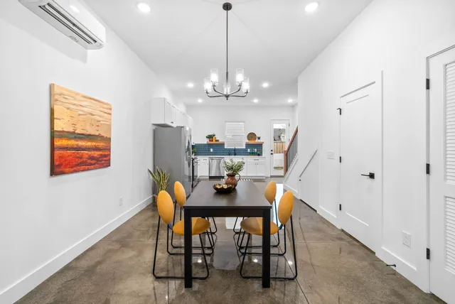 a view of a dining room with furniture and chandelier