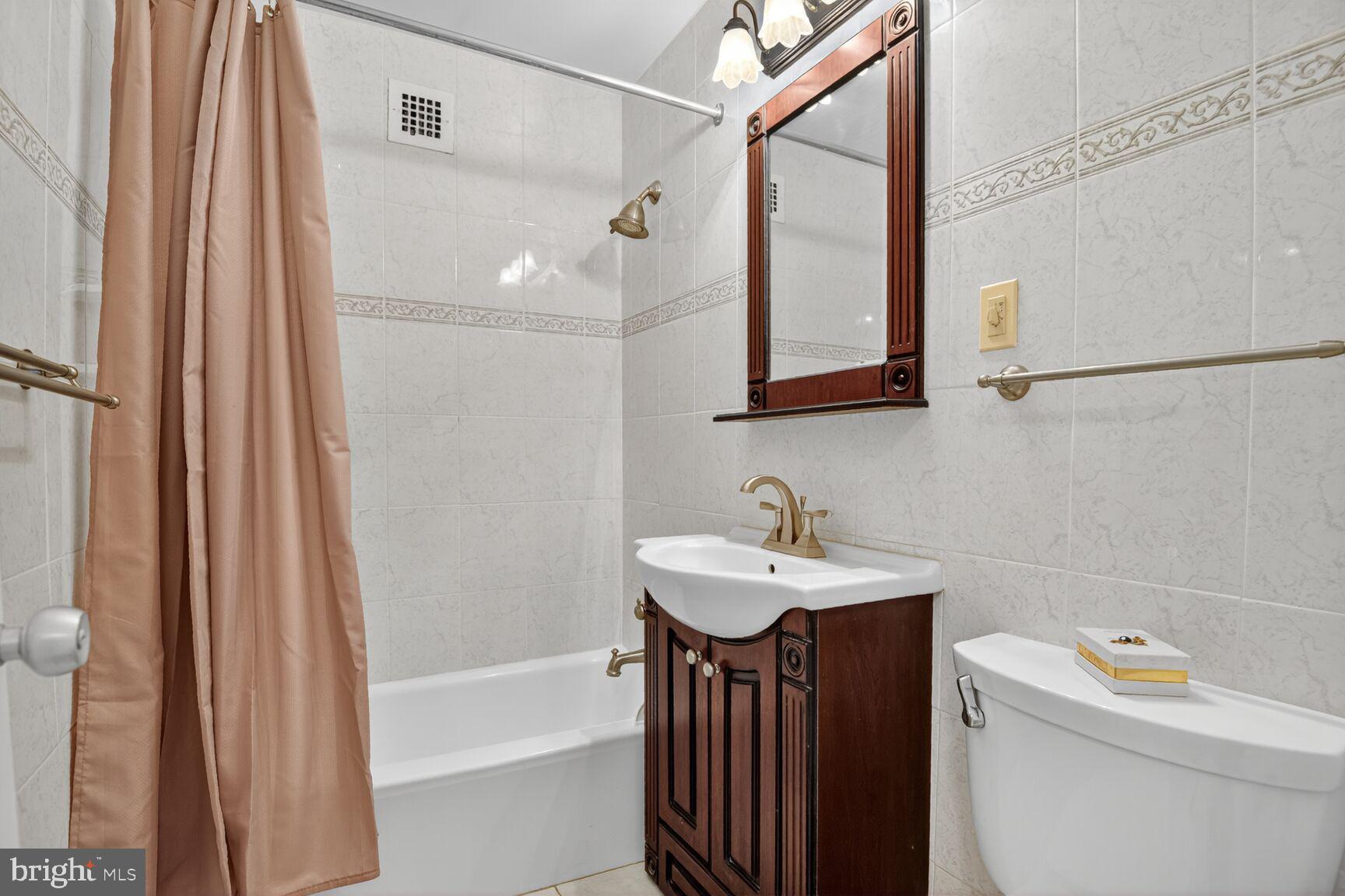 3000 Spout Run Parkway, Unit A306 Arlington, VA 22201 - Photo 16 of 26 a bathroom with a sink a toilet and shower