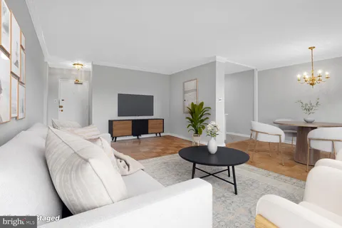 a living room with furniture a lamp and a chandelier