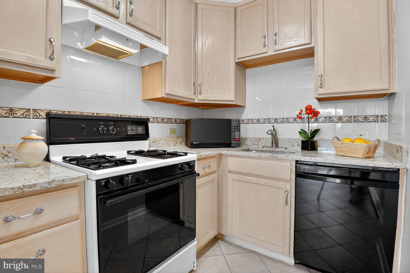 3000 Spout Run Parkway, Unit A306 Arlington, VA 22201 - Photo 9 of 26 a kitchen with stainless steel appliances granite countertop a stove and a cabinets