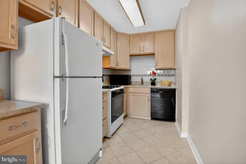 a kitchen with a white cabinets and white appliances
