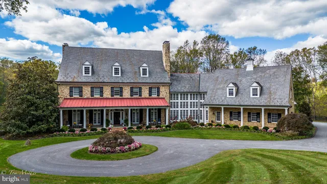 front view of a brick house with a yard