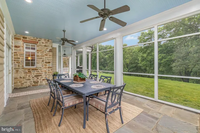 a aerial view of a house with swimming pool and trees in the background