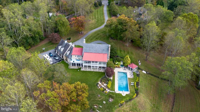 a living room with furniture a flat screen tv and a chandelier