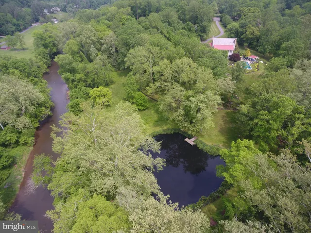 a dining hall with stainless steel appliances kitchen island granite countertop a sink a stove a dining table and chairs