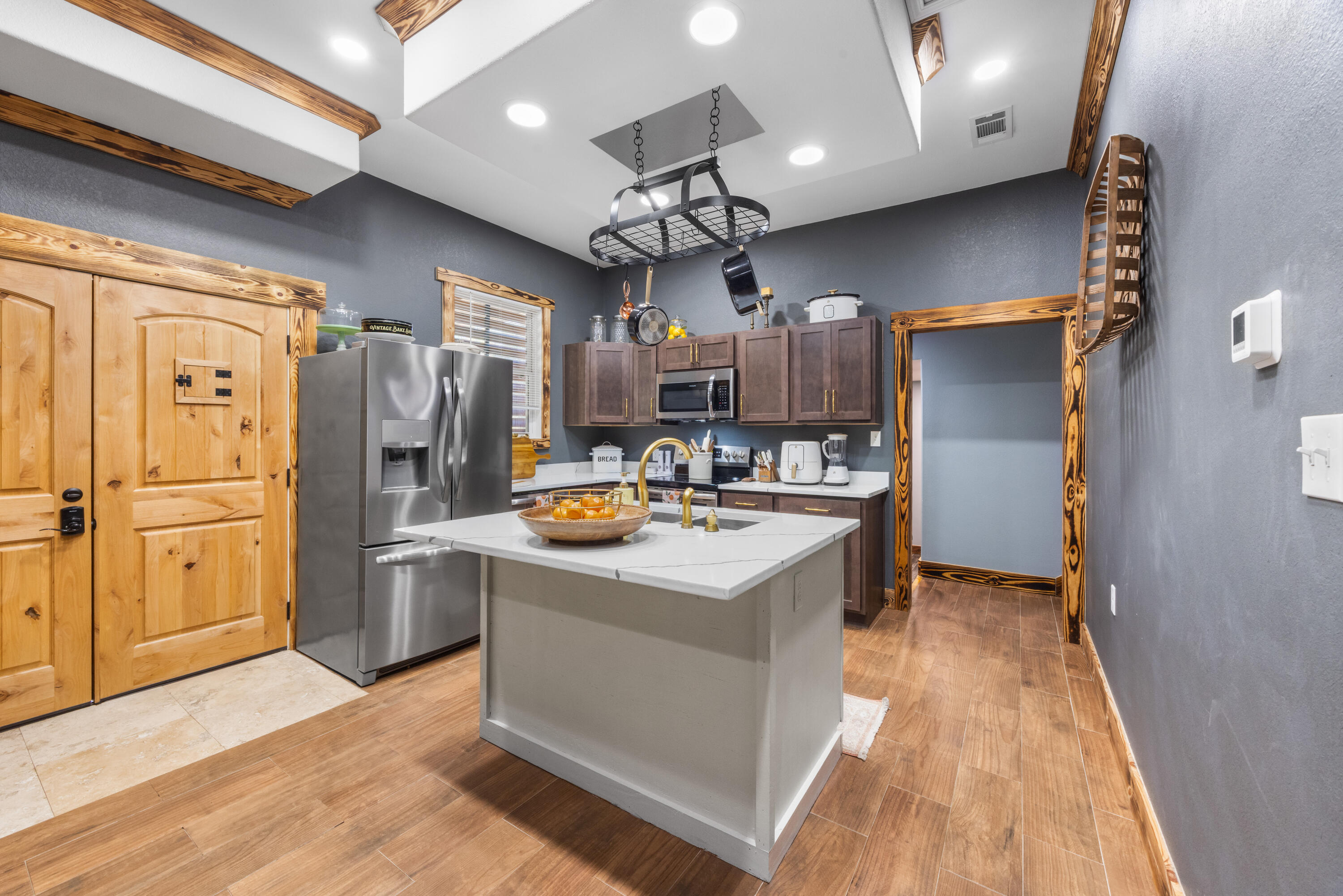 981 East Chestnut Avenue Crestview, FL 32539 - Photo 20 of 80 a kitchen with stainless steel appliances granite countertop a refrigerator a sink dishwasher a stove and a dining table with wooden floor