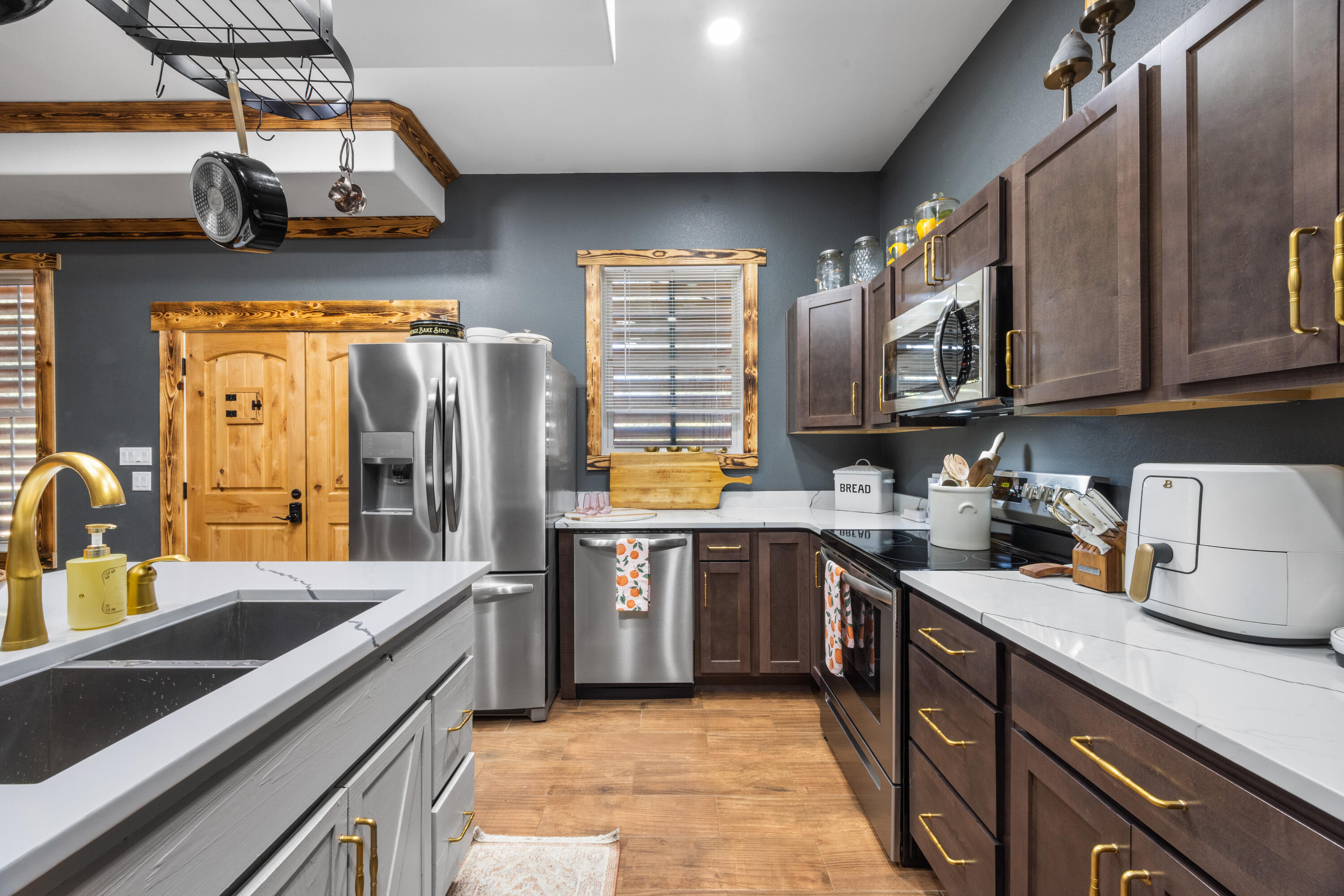981 East Chestnut Avenue Crestview, FL 32539 - Photo 21 of 80 a kitchen with stainless steel appliances granite countertop a sink stove and refrigerator