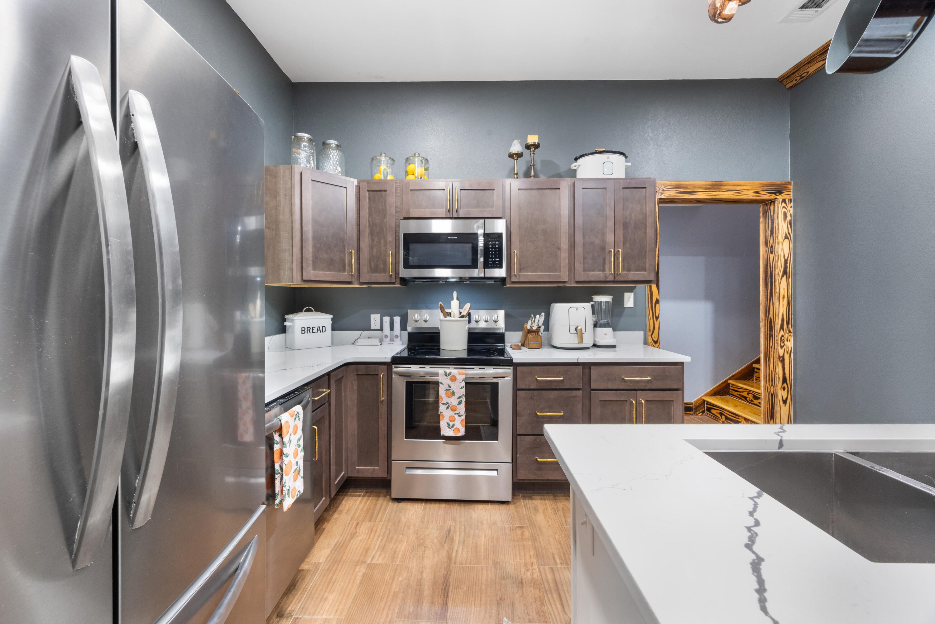 981 East Chestnut Avenue Crestview, FL 32539 - Photo 23 of 80 a kitchen with stainless steel appliances granite countertop a refrigerator a stove and a sink