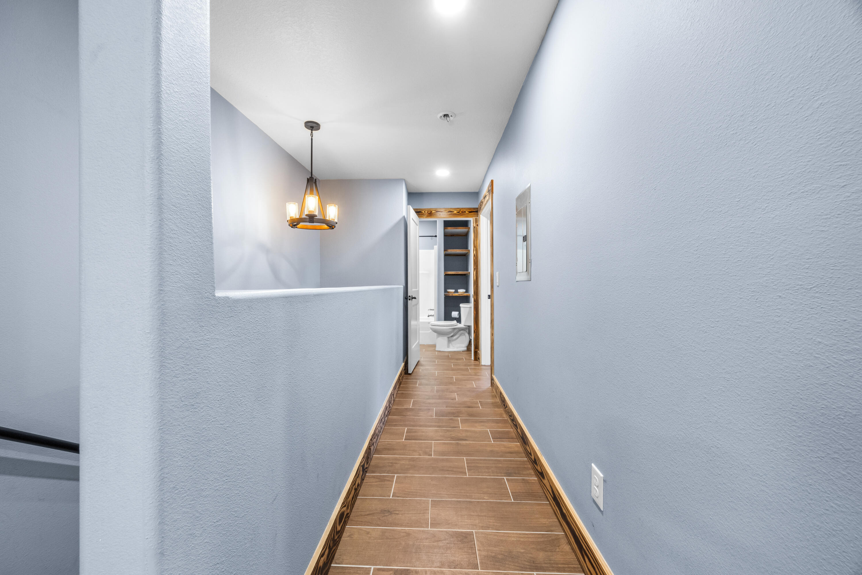 981 East Chestnut Avenue Crestview, FL 32539 - Photo 52 of 80 a view of a hallway with wooden floor and a staircase