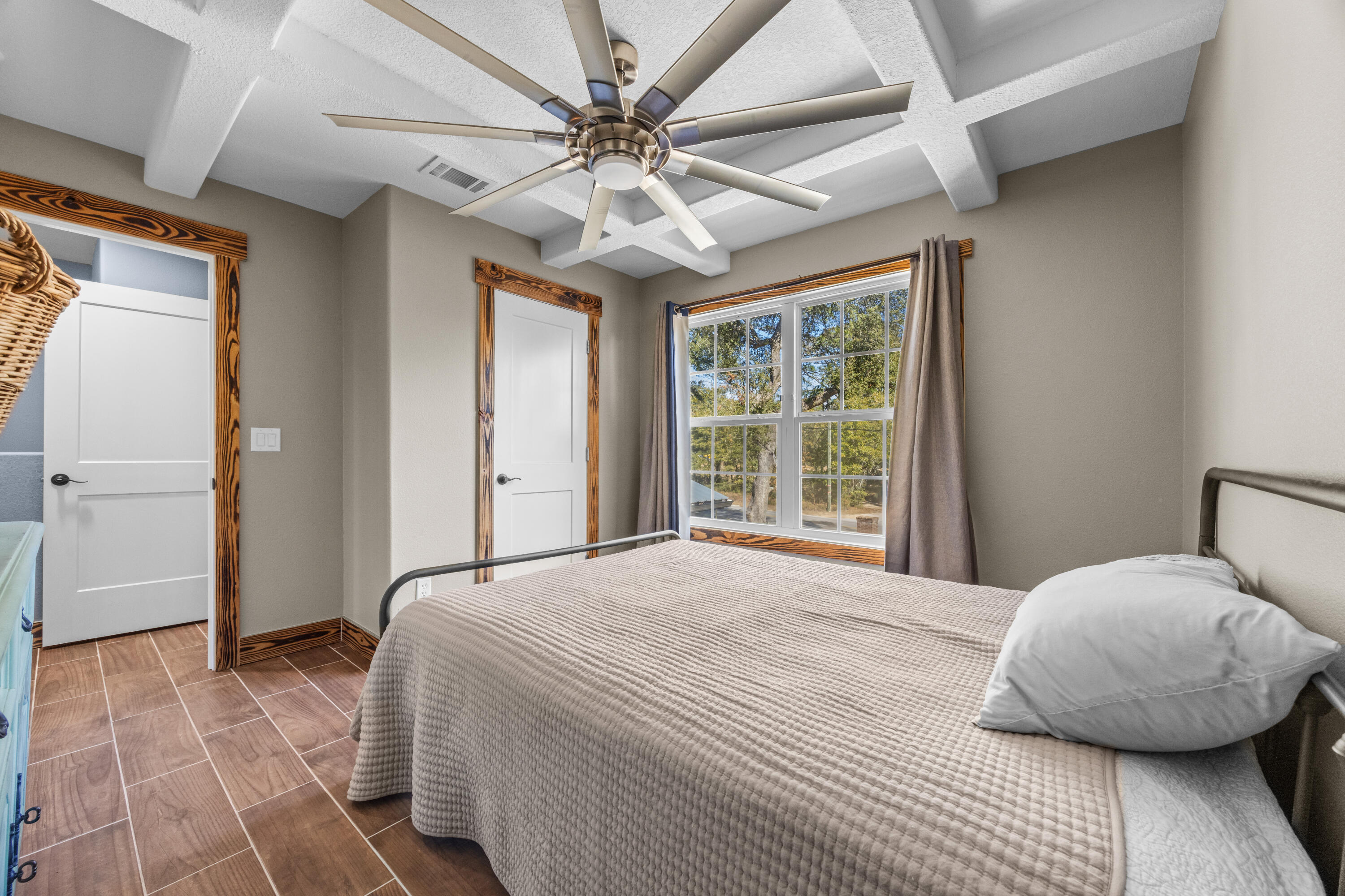 981 East Chestnut Avenue Crestview, FL 32539 - Photo 54 of 80 a bedroom with a large bed and a chandelier