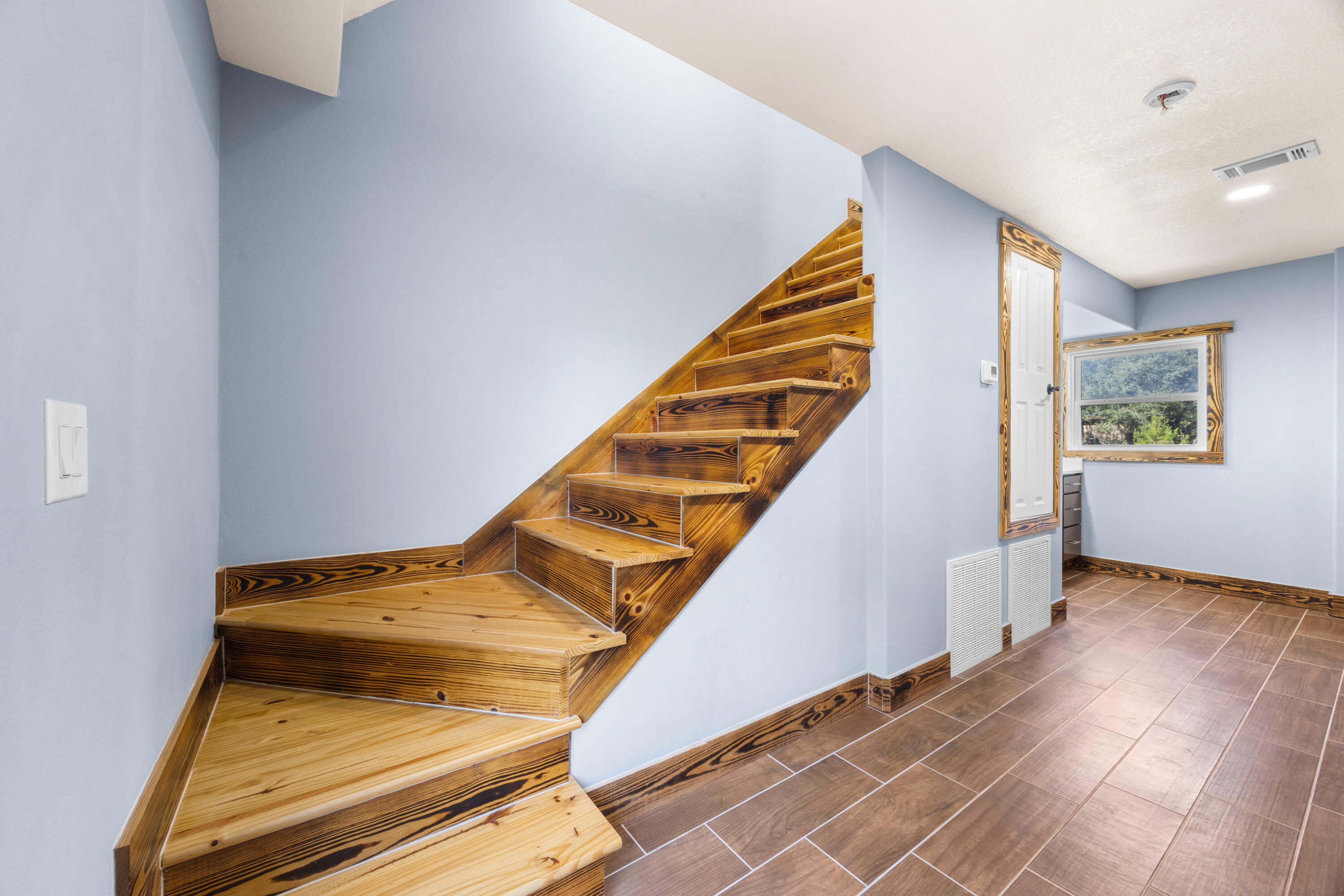 981 East Chestnut Avenue Crestview, FL 32539 - Photo 59 of 80 a view of staircase with wooden floor and stairs