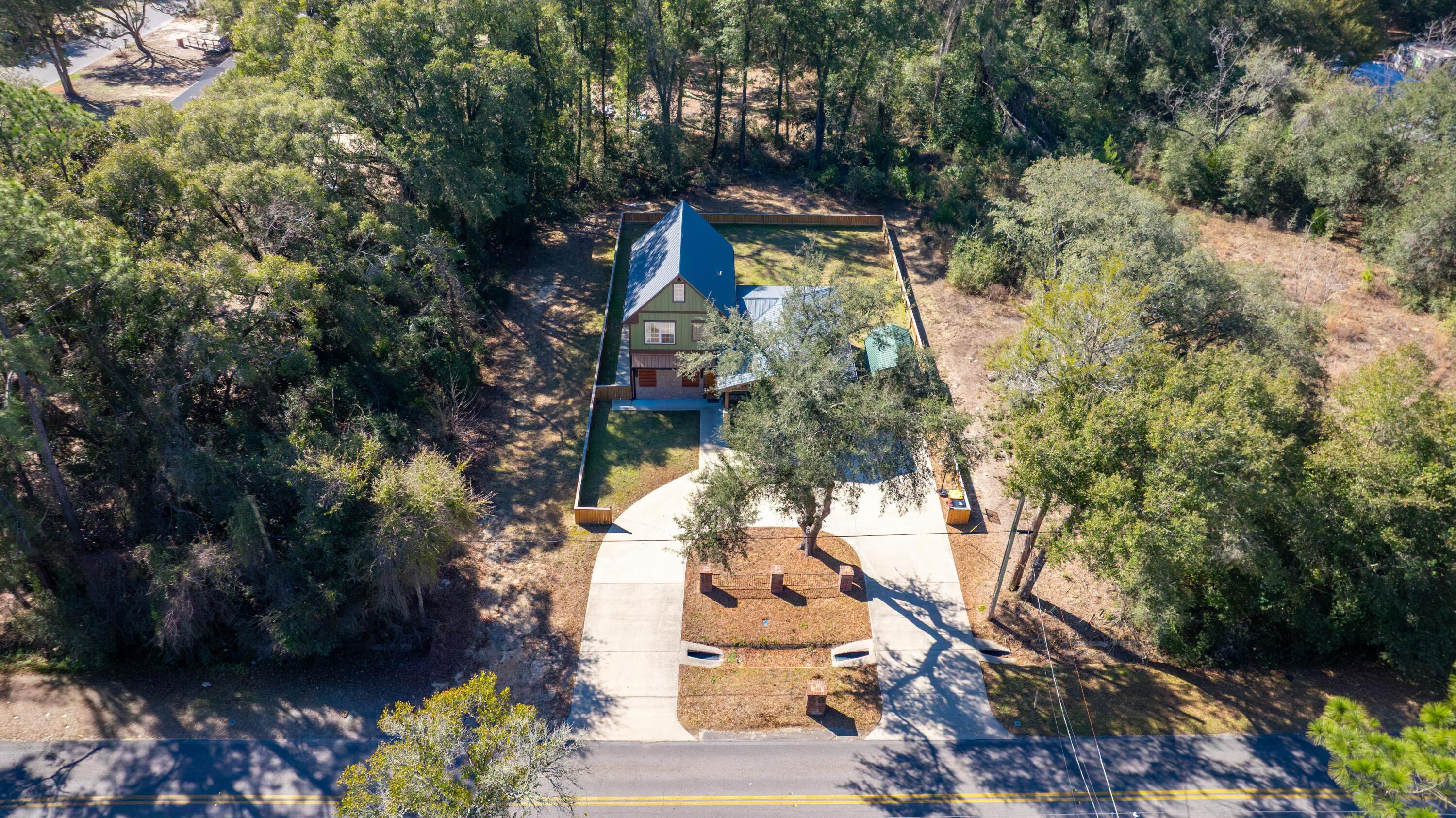 981 East Chestnut Avenue Crestview, FL 32539 - Photo 75 of 80 a backyard of a house with lots of green space