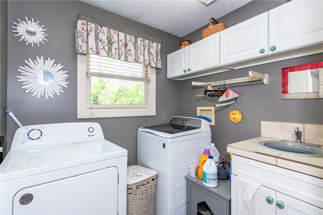 159 East Lytle 5 Points Road Springboro, OH 45066 - Photo 21 of 45 This functional laundry area features ample cabinetry and a utility sink for convenience.