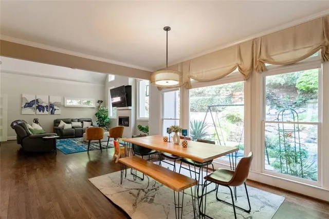 a dining room with furniture window and wooden floor