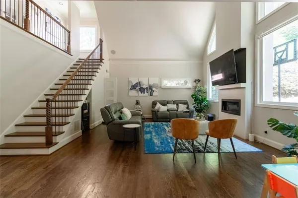 a living room with furniture a flat screen tv and a fireplace