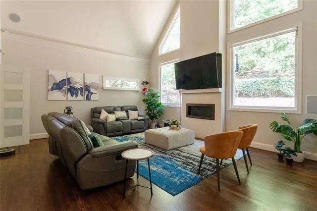 a living room with furniture a flat screen tv and a fireplace