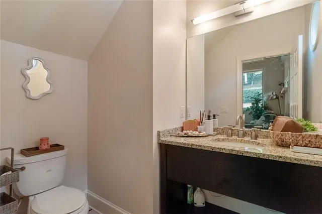 a bathroom with a sink a toilet and mirror