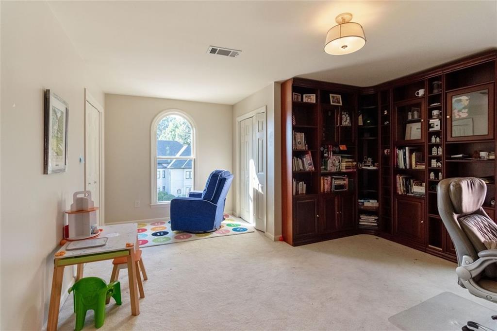 3850 Glenhurst Drive Smyrna, GA 30080 - Photo 20 of 43 a living room with furniture a bookshelf and a window