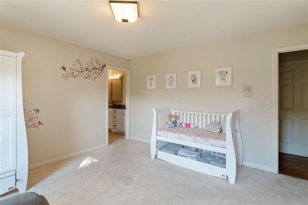 3850 Glenhurst Drive Smyrna, GA 30080 - Photo 25 of 43 a bedroom with a bed and a chandelier